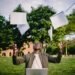 Man celebrating exam success by throwing papers into the air