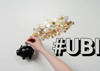 A pggy bank with coins laid out around it. Contains the hashtag u.b.i.