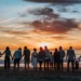 A large family watching the sunset at the beach
