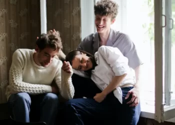 Two men and a woman in a polygamous relationship