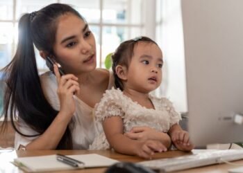 Mother and daughter using a computer and internet during mother working from home