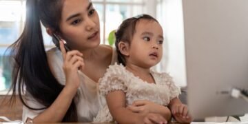 Mother and daughter using a computer and internet during mother working from home