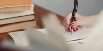 hand with pen writing a dissertation