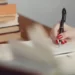 hand with pen writing a dissertation